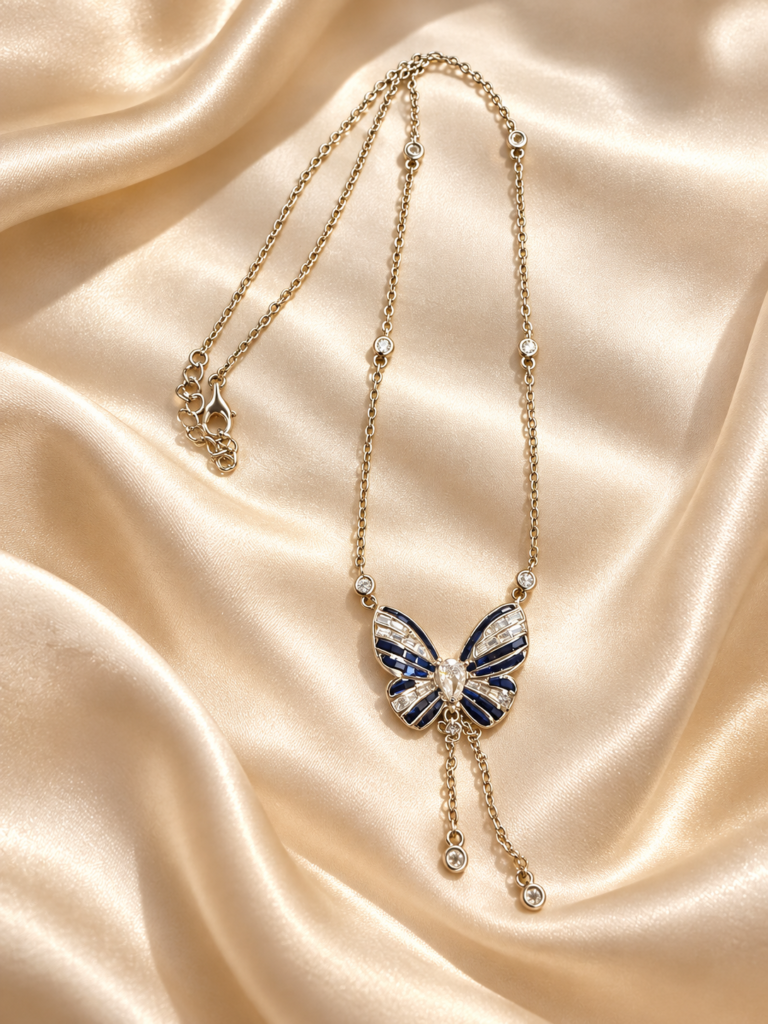 Navy butterfly pendant necklace with clear stone accents and twin drops